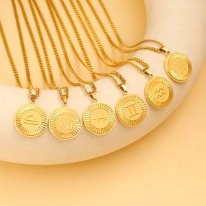 Detailed macro view of 18K gold-plated zodiac pendant necklaces with Cuban chain link style