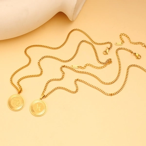 Detail of 18K gold zodiac pendant necklace with Virgo and Pisces charms and K18 hallmark