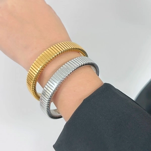 Detail of 18K gold and silver titanium steel bangles with textured tube design