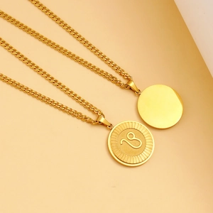 Detail of gold Leo zodiac pendant with chunky curb chain and smooth polished disc charm