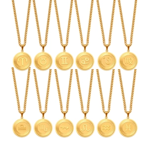 Set of 12 zodiac gold coin necklaces with constellation pendants on white background