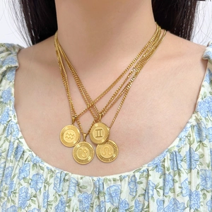 Vintage 18K gold plated stainless steel zodiac coin necklace layered on a female model