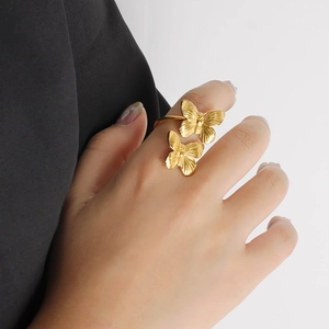 Detailed close-up of adjustable double butterfly ring in 18K gold-plated stainless steel