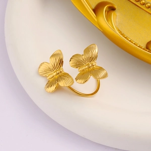 Close-up of golden 18K titanium steel ring featuring detailed double butterfly textures