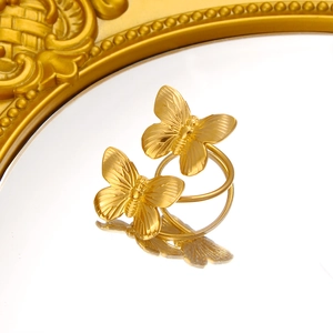Elegant 18K gold butterfly wrap open ring with brushed texture on reflective surface
