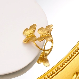 Detailed macro shot of a golden double butterfly ring with intricate wing textures