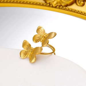 Detailed close-up of a gold 18K titanium steel butterfly open ring with matte texture