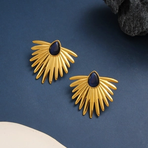 Detailed macro view of 18K gold fan earrings with royal blue teardrop stone