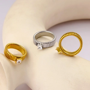 Detail view of 18K gold and silver elastic rings with square zircon in four-prong setting