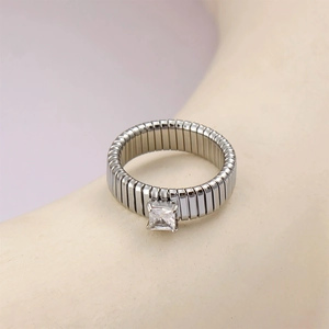 Macro shot of silver square zircon ring with flexible geometric metal band detail