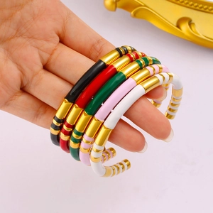 Detail of colorful enamel bamboo C-shape bangles in 18K gold-plated stainless steel