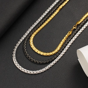 Close-up of three stainless steel box chains in silver, black, and 18K gold finishes
