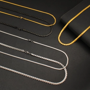 Detailed macro view of 4mm and 6mm stainless steel box chains in gold, black, and silver colors