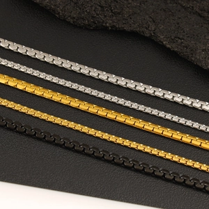Close-up of assorted stainless steel box chains in gold, silver and matte black finish