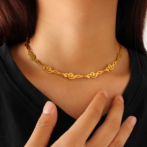 Detailed close-up of 18K gold-plated treble clef music notes necklace on model
