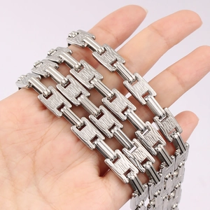 Hand holding silver stainless steel link chain with textured bark finish and rectangle links