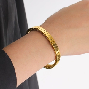 Détail du bracelet extensible en acier inoxydable doré 18 carats à texture nervurée