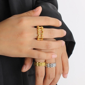 Hip hop style gold and silver bicycle chain rings for women shown on hand