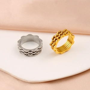 Detailed view of silver and gold bicycle chain rings with hollow mechanical gear structure