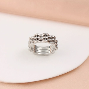 Detailed macro shot of silver industrial gear ring on a white round display stand