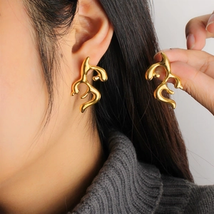 Elegant 18K gold-plated irregular lava antler earrings worn by a model in a luxury style