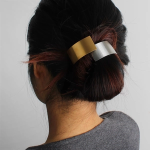 Minimalist bicolour rectangle hair tie showing gold and silver brushed metal plates