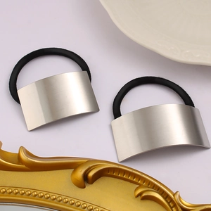 Sleek brushed stainless steel hair tie set with minimalist metal curve and black elastic band