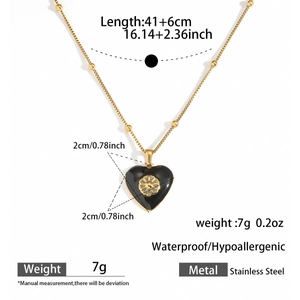 Detailed view of black enamel heart pendant on a 41+6cm golden stainless steel bead chain