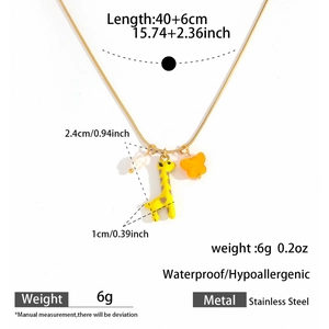 Detail of 18k gold plated snake chain with giraffe, butterfly and pearl charms