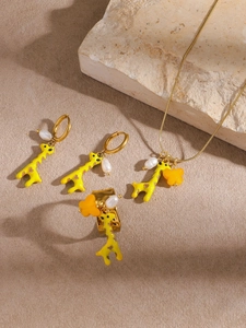 Detailed set of giraffe jewelry with gold plating, yellow enamel, and pearl accents