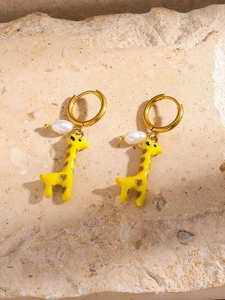 Detail of gold giraffe earrings with baroque pearls and yellow enamel heart accents