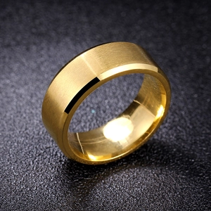 Macro detail of golden stainless steel ring with brushed matte finish and polished edges