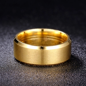 Detail of 8mm gold titanium steel ring with brushed surface and beveled edges