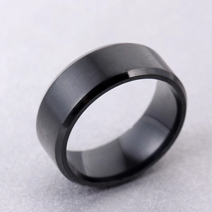 Macro view of matte black stainless steel ring featuring beveled edges and brushed finish