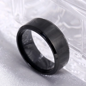 Detail of matte black titanium steel ring with brushed finish and polished inner band