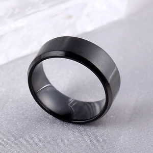 Detailed close-up of a black brushed titanium steel ring with polished beveled edges