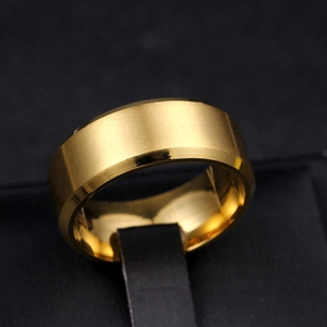 Close-up of 8mm gold titanium ring with brushed surface and polished beveled edges