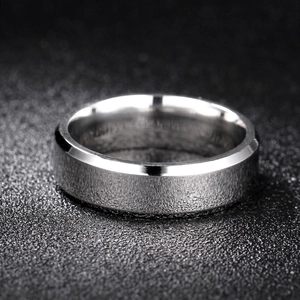 Macro detail of silver titanium steel ring with double-beveled edges and matte texture
