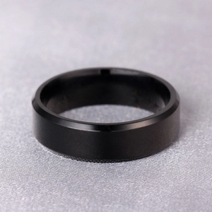 Detailed view of black 316L titanium steel ring with double beveled edges and polished finish