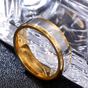 Macro shot of two-tone gold and silver stainless steel ring with polished edges