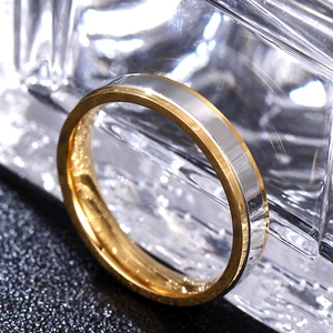 Macro shot of two-tone stainless steel ring with silver center and gold edges