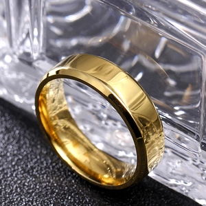 Macro shot of 8mm gold polished bevel edged titanium steel ring for men on crystal