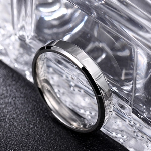 Detail showing high-polish double beveled edges on a minimalist silver steel ring