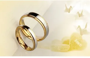 Close-up of gold and silver two-tone couple rings with a polished finish and reflective surface