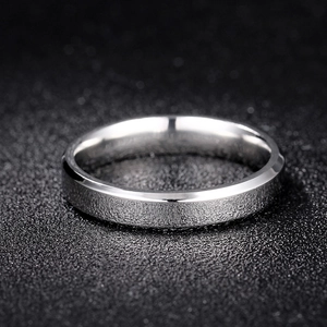 Macro shot of silver titanium steel ring with brushed finish and polished beveled edges