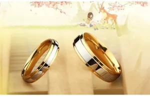 Close-up of gold and silver bicolor tungsten steel couple rings with polished finish