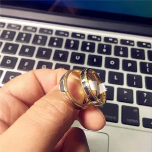 Close-up of polished gold and silver toned couple rings with smooth metallic finish
