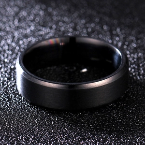 Macro detail of black brushed stainless steel ring with polished beveled edges