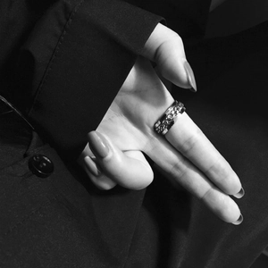 Macro view of silver titanium steel ring with rotating cuban chain detail on a hand