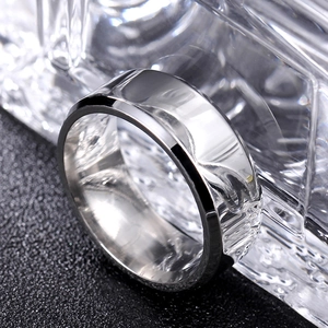 Close-up of 8mm silver titanium steel ring with double beveled edges and polished surface